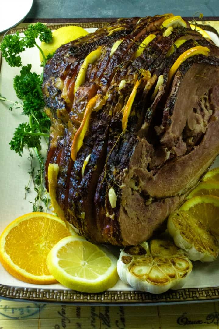Citrus Stuffed Spiral Ham -Citrus slices, garlic and herbs steam in flavor as this holiday favorite bakes!
