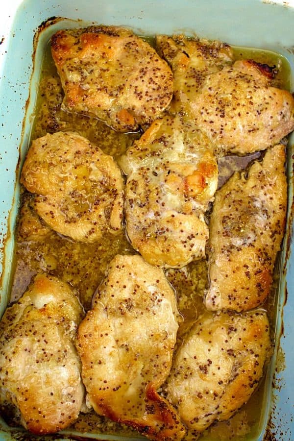 Pan full of baked chicken with pan drippings