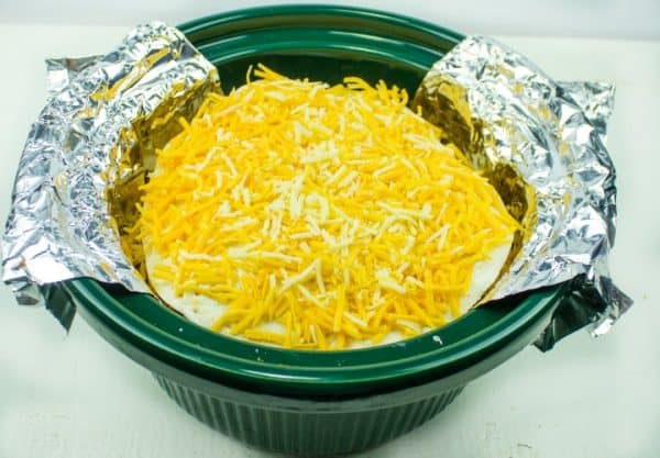 Prepping tortillas, meat and cheese for the slow cooker