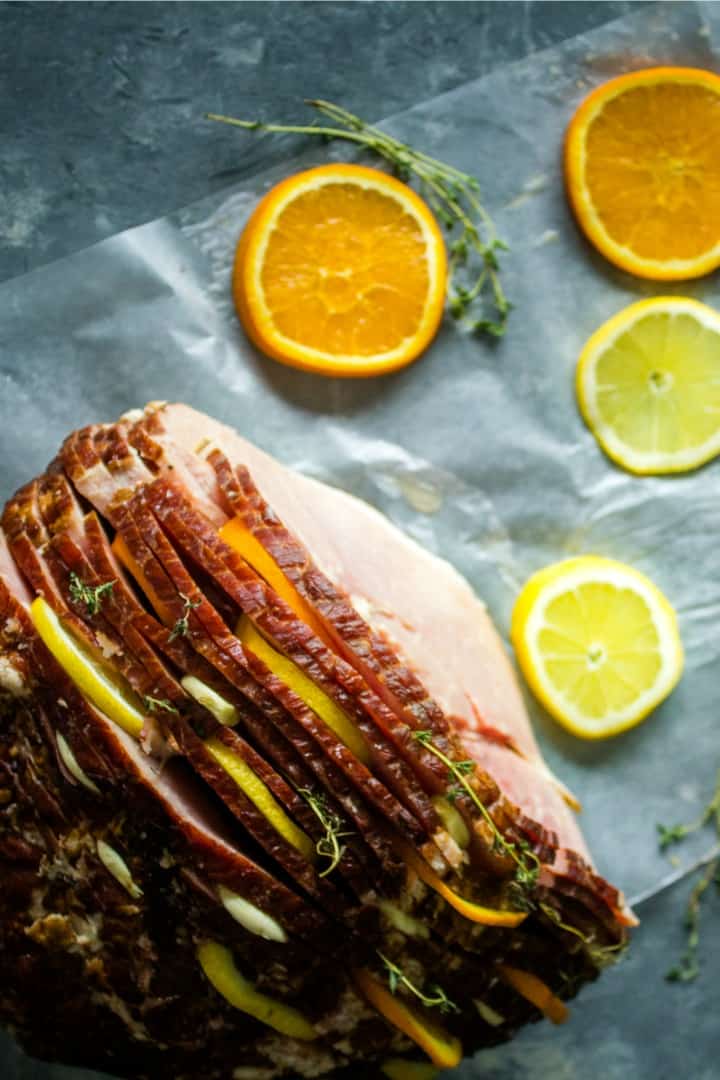 Citrus Stuffed Spiral Ham - Citrus slices, garlic and herbs steam in flavor as this holiday favorite bakes!