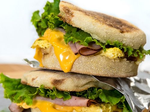 Easy make ahead freezer breakfast sandwiches are ready for a start the day meal on-the-go. Prep a batch with herb seasoned eggs, ham and sliced cheese in under 25 minutes!