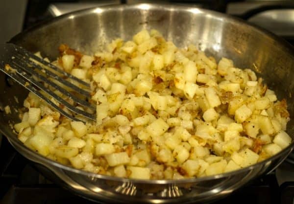 diced potatoes cooking in skillet