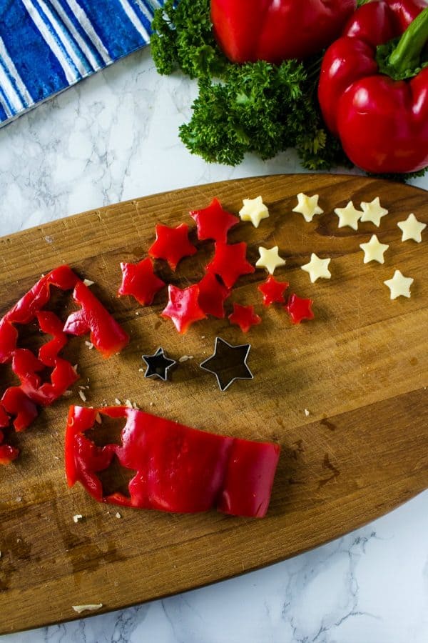 mini red pepper and cheese star cutouts to decorate cheese ball