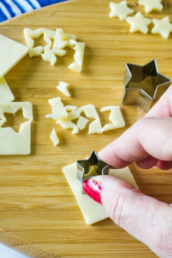 making tin star shape cutouts of cheese