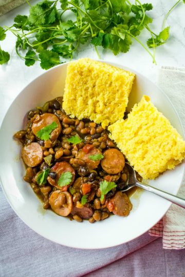 Smoked sausage, canned baked and black beans, tomatoes with green chilies and green bell pepper make an easy weeknight dinner with a sweet and spicy sauce.