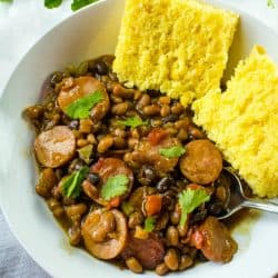 Smoked sausage, canned baked and black beans, tomatoes with green chilies and green bell pepper make an easy weeknight dinner with a sweet and spicy sauce.