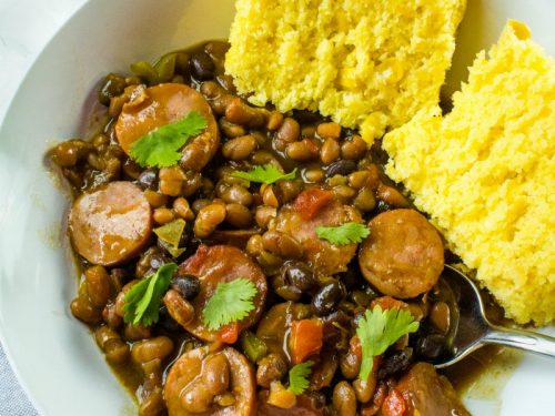Smoked sausage, canned baked and black beans, tomatoes with green chilies and green bell pepper make an easy weeknight dinner with a sweet and spicy sauce.