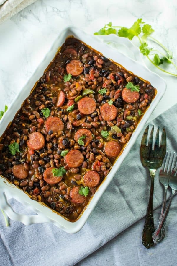 Smoked sausage, canned baked and black beans, tomatoes with green chilies and green bell pepper make an easy weeknight dinner with a sweet and spicy sauce.