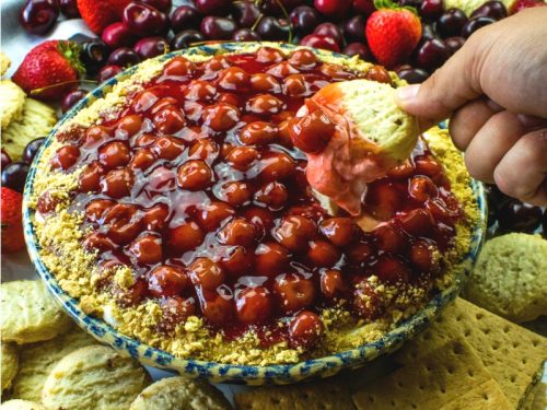 Greek yogurt, whipped cream, cream cheese and cherry pie filling combine to make this easy and irresistible party dip everyone loves!