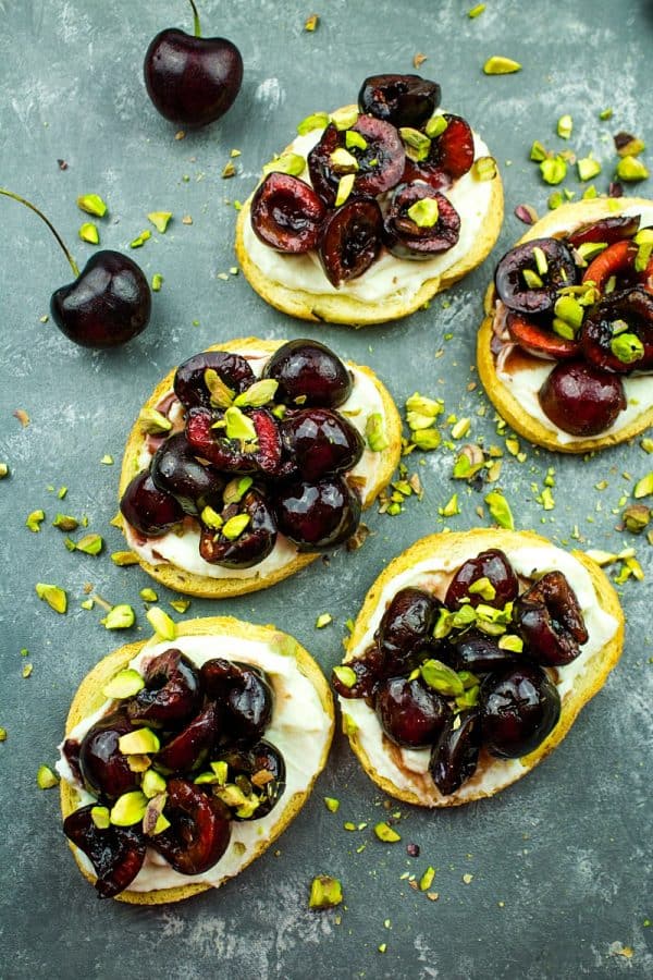 Cherry Pistachio Ricotta Crostini - Crisp toasts, cherries, sweetened ricotta and pitachios are layered to make these fabulous elegant party appetizers! 