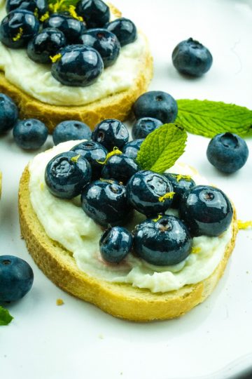 Blueberry Honey Whipped Ricotta Crostini -Blueberries, ricotta cheese and honey are paired to make this elegant perfect party appetizer!