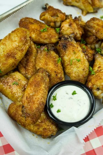 Make these EASY oven-baked chicken wings, coated in a brown sugar and Cajun spice rub.