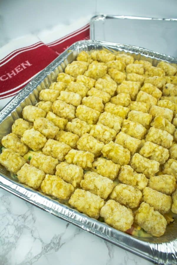 Full of chicken, vegetables and a creamy sauce that makes an irresistible family size chicken tater tot casserole freezer meal!