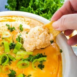 An EASY Buffalo Chicken Dip recipe that preps in minutes, then warms in the slow cooker! Great for parties or game day!