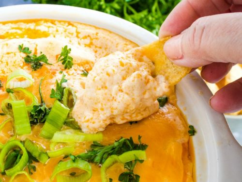An EASY Buffalo Chicken Dip recipe that preps in minutes, then warms in the slow cooker! Great for parties or game day!
