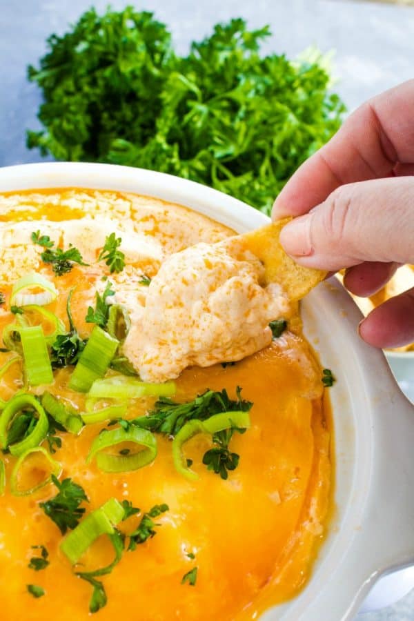 An EASY Buffalo Chicken Dip recipe that preps in minutes, then warms in the slow cooker! Great for parties or game day!