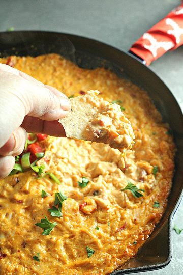 Creamy and cheesy, this Buffalo Chicken Dip is a favorite spicy party appetizer. Simple to make with ingredients like shredded chicken, wing sauce, ranch dressing and mozzarella cheese.