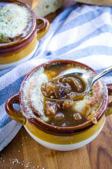 Classic French Onion Soup recipe is made with perfectly caramelized onions, toasted french bread and two kinds of melted cheese on top!