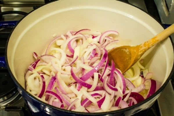 Red and yellow onions ready to caramelize in pot