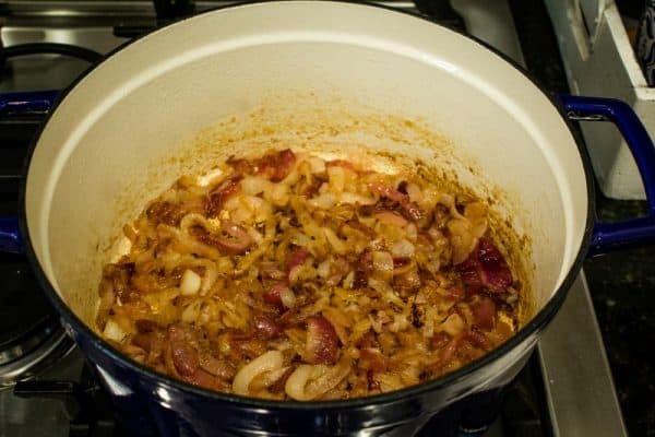 caramelized red and yellow onions in blue pot