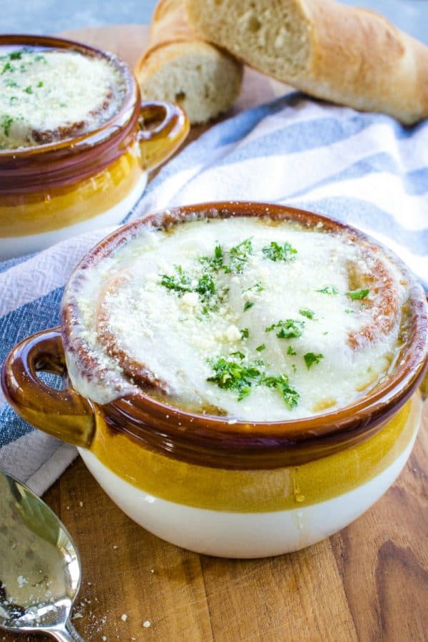 Classic French Onion Soup recipe is made with perfectly caramelized onions, toasted french bread and two kinds of melted cheese on top!