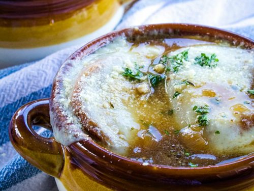 Classic French Onion Soup recipe is made with perfectly caramelized onions, toasted french bread and two kinds of melted cheese on top!