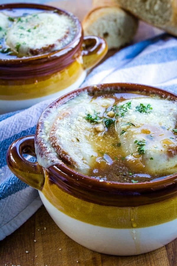 Classic French Onion Soup recipe is made with perfectly caramelized onions, toasted french bread and two kinds of melted cheese on top!