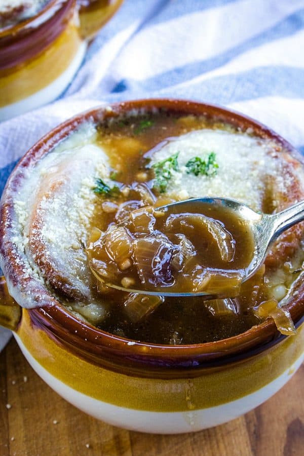 Classic French Onion Soup recipe is made with perfectly caramelized onions, toasted french bread and two kinds of melted cheese on top!