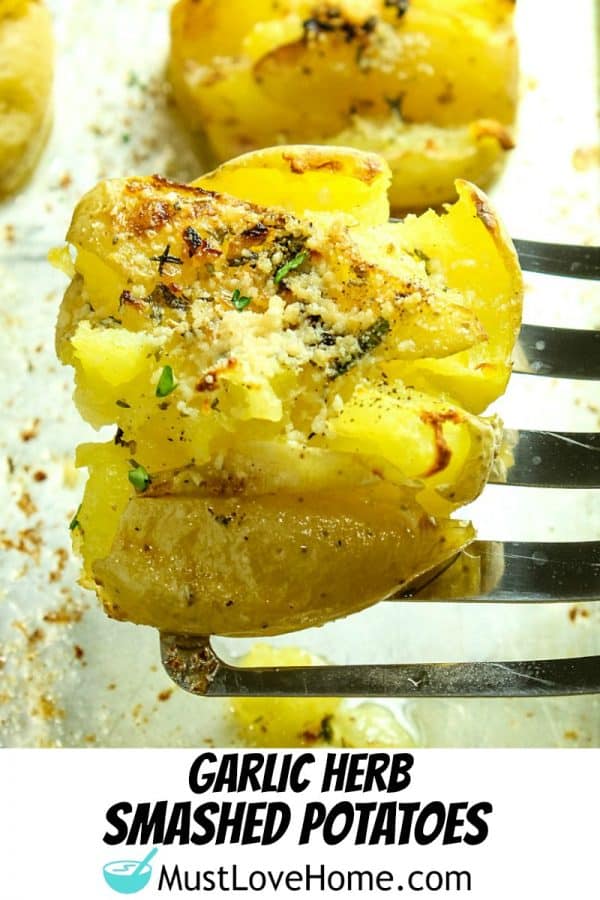 Garlic Herb Smashed Potatoes! Boiled potatoes smashed in their skins, then drizzled with butter, herbs and garlic and broiled until crispy brown. Parmesan cheese adds a tangy final touch.