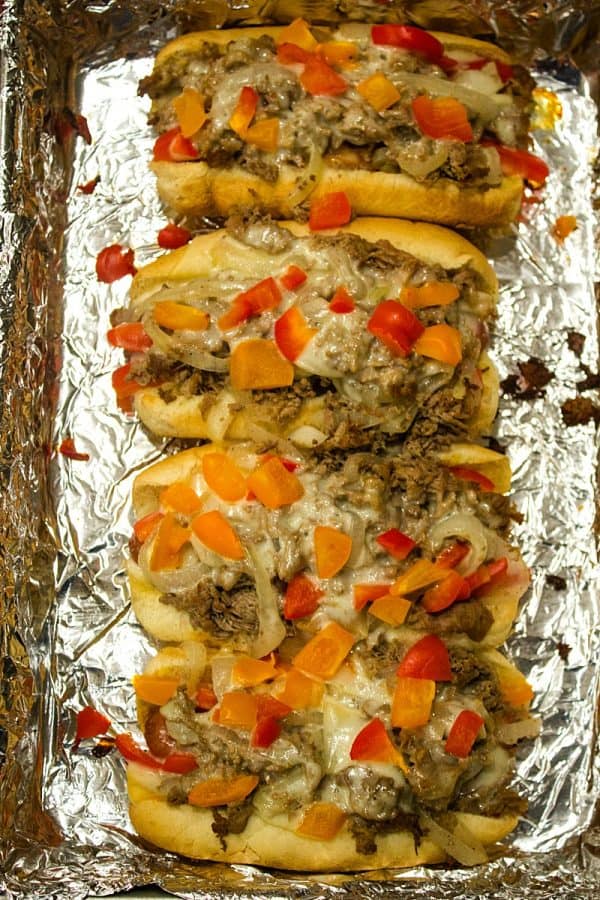 Make dinner quick and simple with this hearty cheese steak hot dog recipe.  They're finished in the oven - with melted cheese,  seasoned steak, vegetables and a toasty bun. 