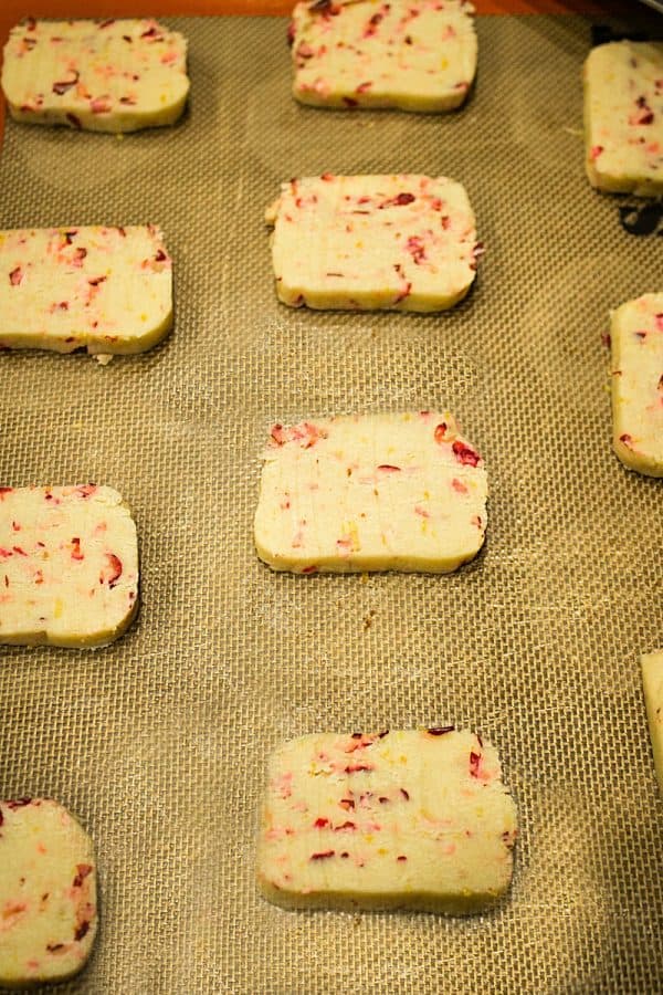 Cranberry Citrus Shortbread Cookies on baking mat ready for the oven.