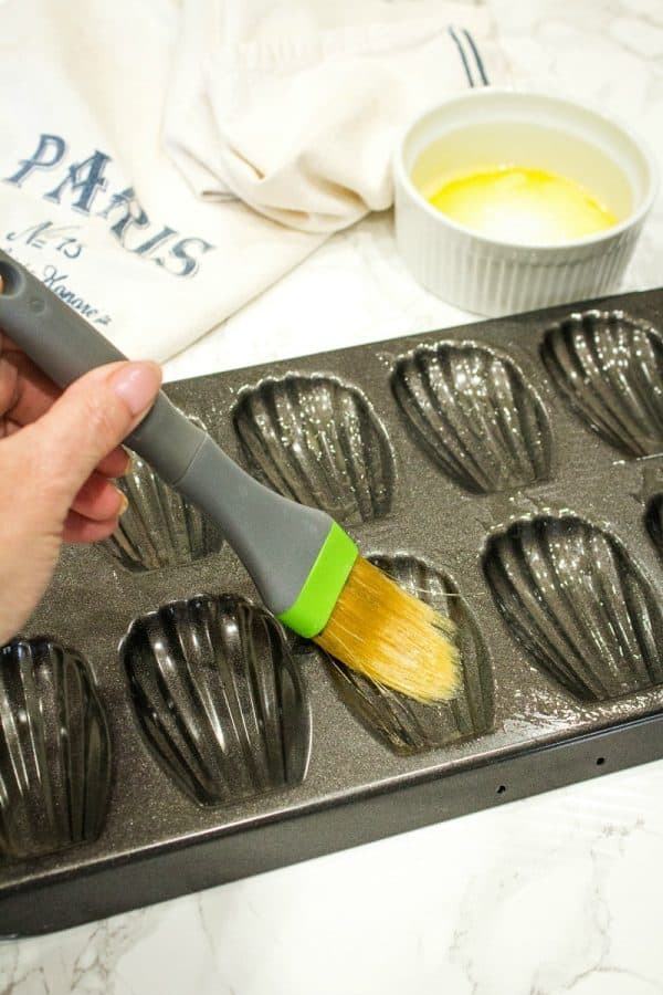 Easy Holiday Madeleines - French butter cookie cakes that are golden crisp on the outside and soft and spongy in the middle. These teacakes, dipped in white chocolate and decorated for the holidays, are surprisingly easy to make with the most basic ingredients. 