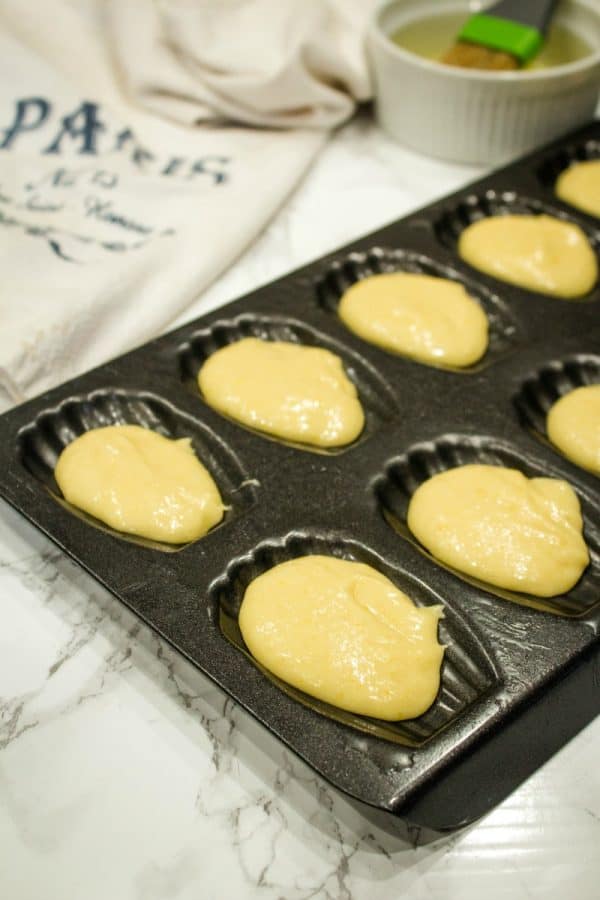 Easy Holiday Madeleines - French butter cookie cakes that are golden crisp on the outside and soft and spongy in the middle. These teacakes, dipped in white chocolate and decorated for the holidays, are surprisingly easy to make with the most basic ingredients. 