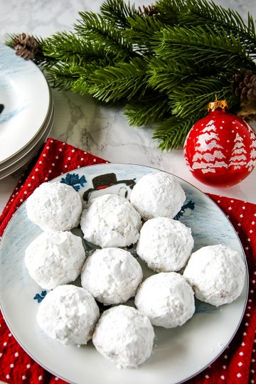 Chocolate Chip Snowball Cookies - filled with melting chocolate chips and festive sprinkles, these sugar dusted cookies are a favorite holiday cookie recipe.