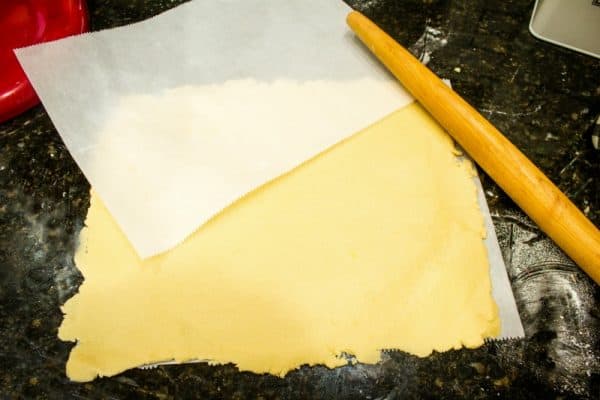 Rolled out sugar cookie dough for raspberry pecan swirl cookies