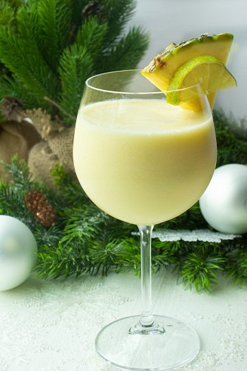 Pineapple Paradise Margarita is a smooth and delicious winter cocktail, guaranteed to evoke thoughts of sun and sand, made with pineapple tequila, coconut milk and frozen chunks of pineapple!