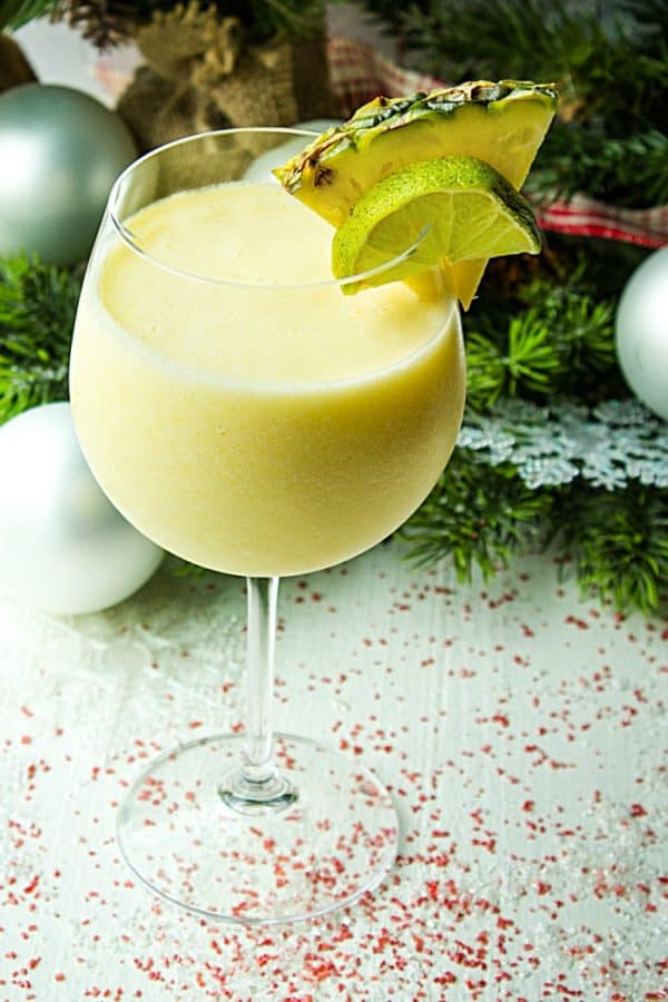 Pineapple Paradise Margarita is a smooth and delicious winter cocktail, guaranteed to evoke thoughts of sun and sand, made with pineapple tequila, coconut milk and frozen chunks of pineapple!