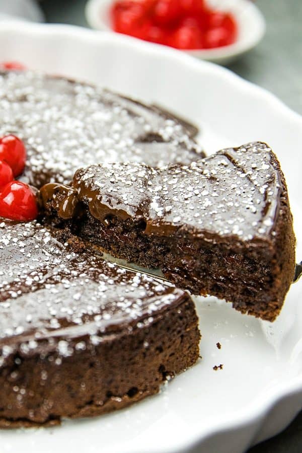 This decadent, gluten-free  Flourless Chocolate Cake with Dried Cherries is for serious chocolate lovers. With only 8 ingredients, including bittersweet chocolate and cocoa powder, it's irresistibly delicious.#mustlovehomecooking