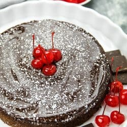 This decadent, gluten-free Flourless Chocolate Cake with Dried Cherries is for serious chocolate lovers. With only 8 ingredients, including bittersweet chocolate and cocoa powder, it's irresistibly delicious.#mustlovehomecooking