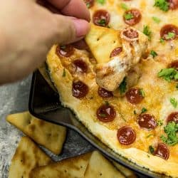 Pepperoni Pizza dip recipe is creamy, cheesy, loaded with spicy pepperoni and totally crave worthy! Serve your pizza dip with pita chips for the ultimate party snack. #mustlovehomecooking