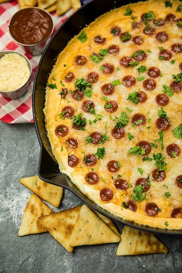 Pepperoni Pizza dip recipe is creamy, cheesy, loaded with spicy pepperoni and totally crave worthy! Serve your pizza dip with pita chips for the ultimate party snack. #mustlovehomecooking