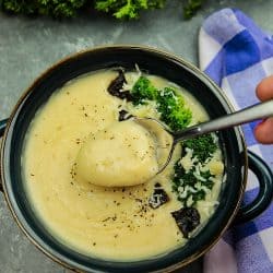 Slow Cooker Alfredo Potato Soup with hearty potatoes, tangy parmesan cheese and a hint of garlic is a cozy bowlful of comfort food ready to warm you on a cold winter night, made easy in the slow cooker.