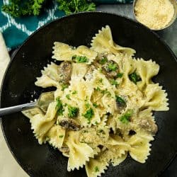 Creamy Mushroom Farfalle Pasta is a simple, easy to make meatless Italian dinner of mushrooms, scallions and seasonings tossed with noodles in a creamy parmesan sauce. #mustlovehomecooking