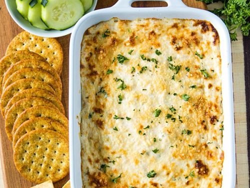 Easy Shrimp Scampi Dip is full of flavor and baked to creamy perfection. This crowd winner is simple to make with cooked shrimp in only 30 minutes. #mustlovehomecooking #shrimpdip #partyfood