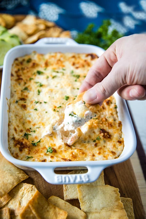 Easy Shrimp Scampi Dip is full of flavor and baked to creamy perfection. This crowd winner is simple to make with cooked shrimp in only 30 minutes. #mustlovehomecooking #shrimpdip #partyfood