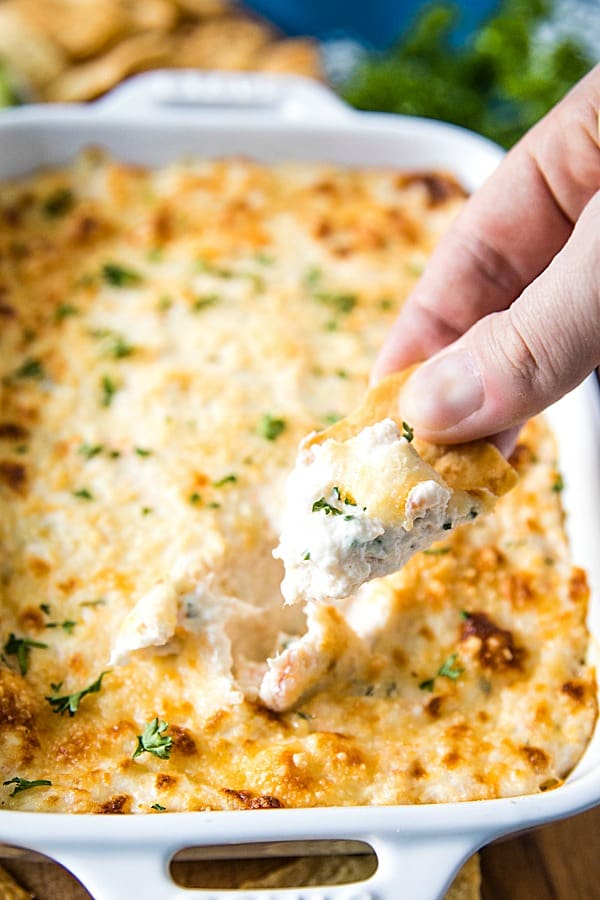 Easy Shrimp Scampi Dip is full of flavor and baked to creamy perfection. This crowd winner is simple to make with cooked shrimp in only 30 minutes. #mustlovehomecooking #shrimpdip #partyfood