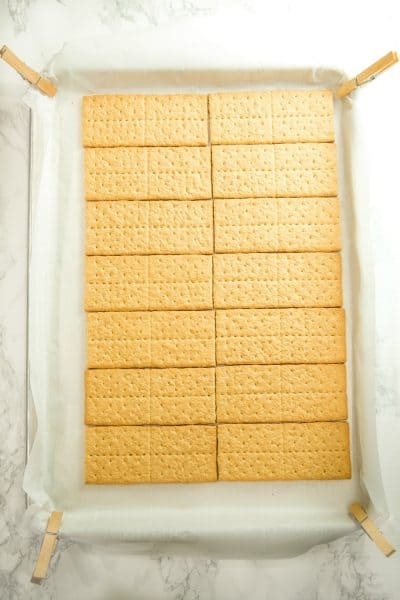 Graham crackers lines up on parchment paper