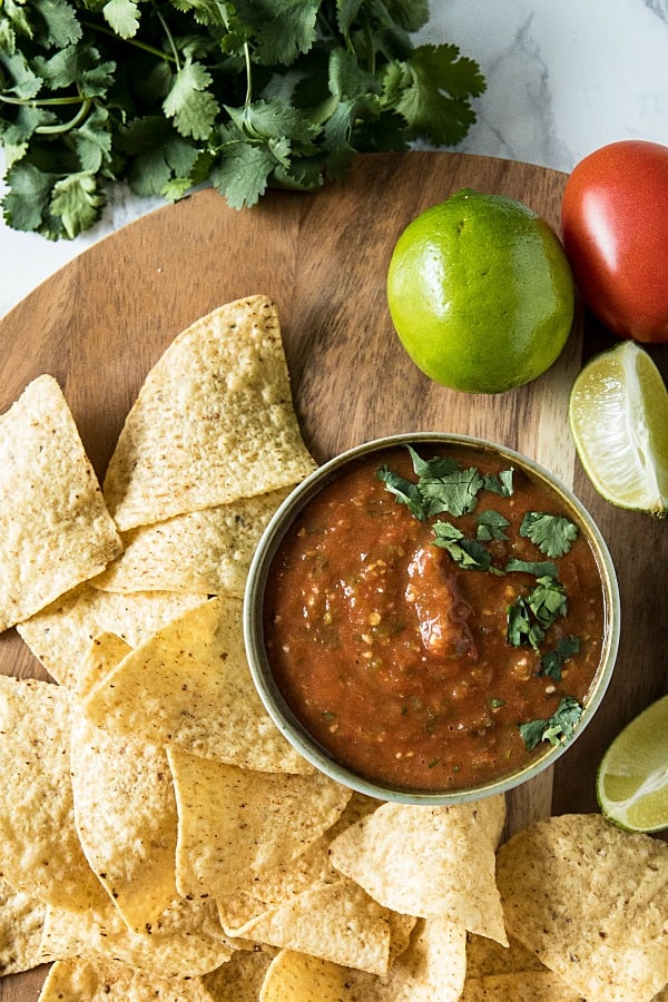 Blackened tomatoes, jalapenos, green onions and olive oil seasoned with lime and honey. It's homemade tomato salsa that's fresh and full of flavor to dip your favorite tortilla chips into. #mustlovehomecooking #salsarecipe