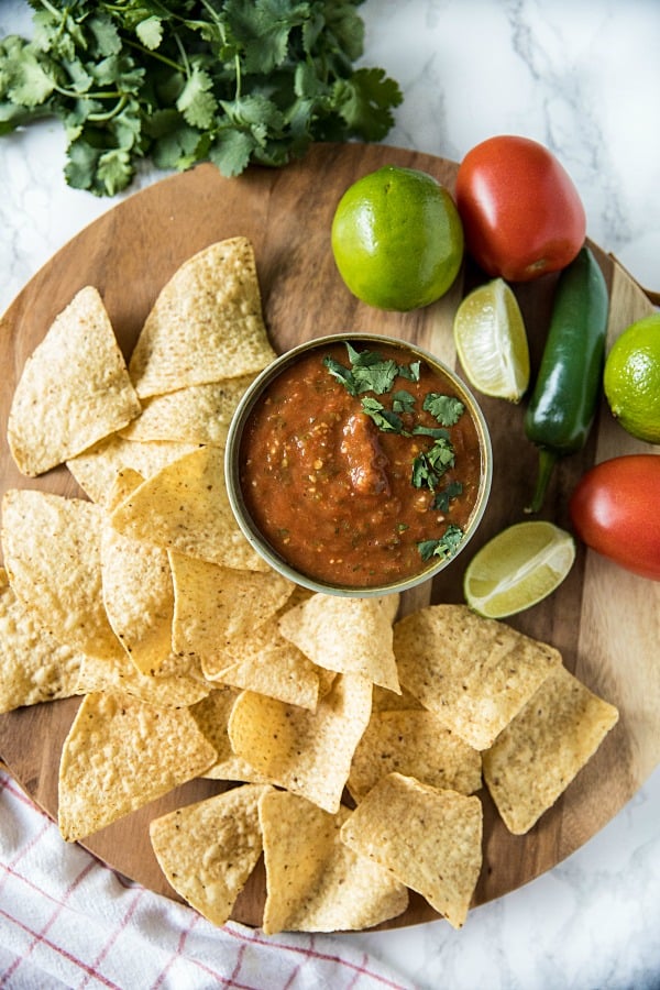 Blackened tomatoes, jalapenos, green onions and olive oil seasoned with lime and honey. It's homemade tomato salsa that's fresh and full of flavor to dip your favorite tortilla chips into. #mustlovehomecooking #salsarecipe