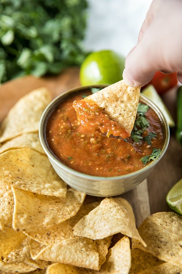 Blackened tomatoes, jalapenos, green onions and olive oil seasoned with lime and honey. It's homemade tomato salsa that's fresh and full of flavor to dip your favorite tortilla chips into. #mustlovehomecooking #salsarecipe